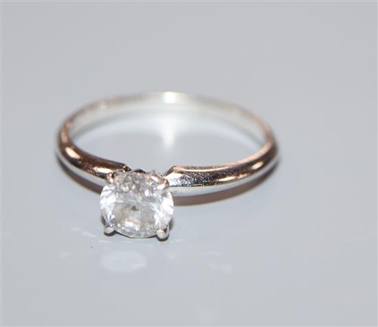 A 14k white metal and solitaire diamond ring, size K/L.